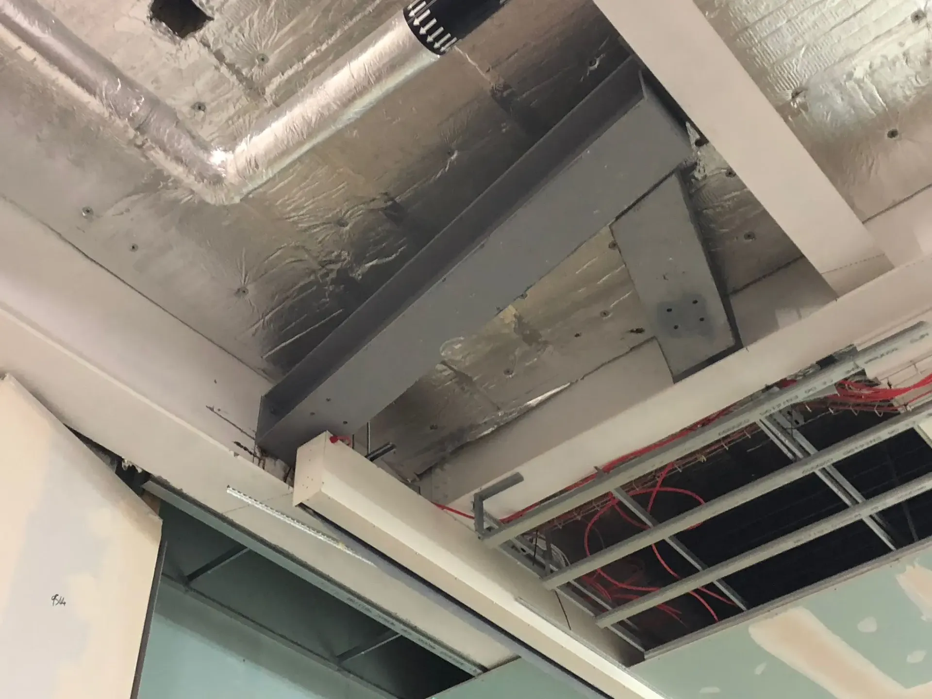 Internal structural steel beam and ceiling insulation installed during a commercial building construction project