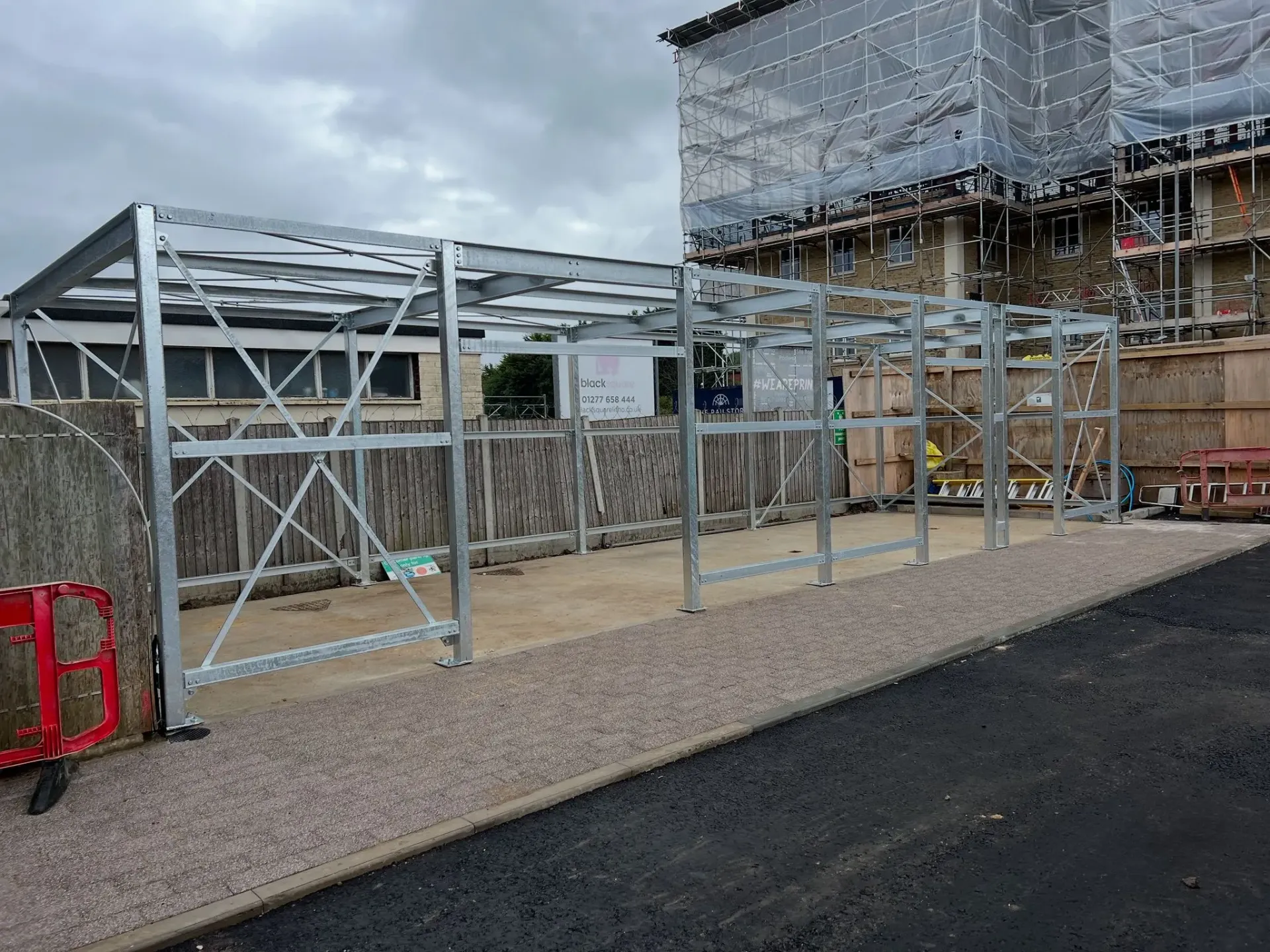 Galvanised steel frame erection for a new commercial unit, demonstrating professional structural installation on a concrete foundation.